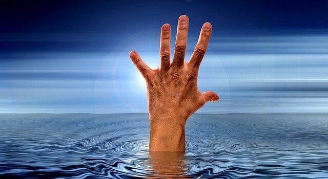 Hand rising from water